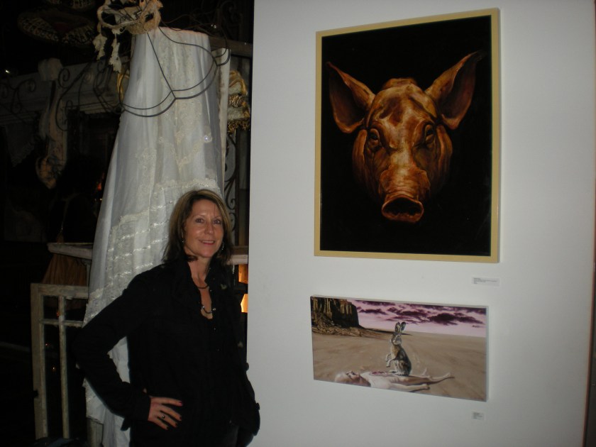 Balliger at multi-species art show, American Anthropological Association conference, New Orleans, 2010, with paintings of pig portrait and rabbit