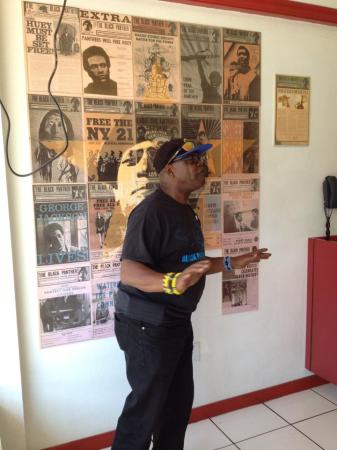 Billy X explains significance of Black Panthers in front of historical posters